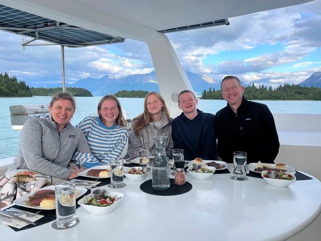 Guests sharing dinner on deck aboard Odyssey