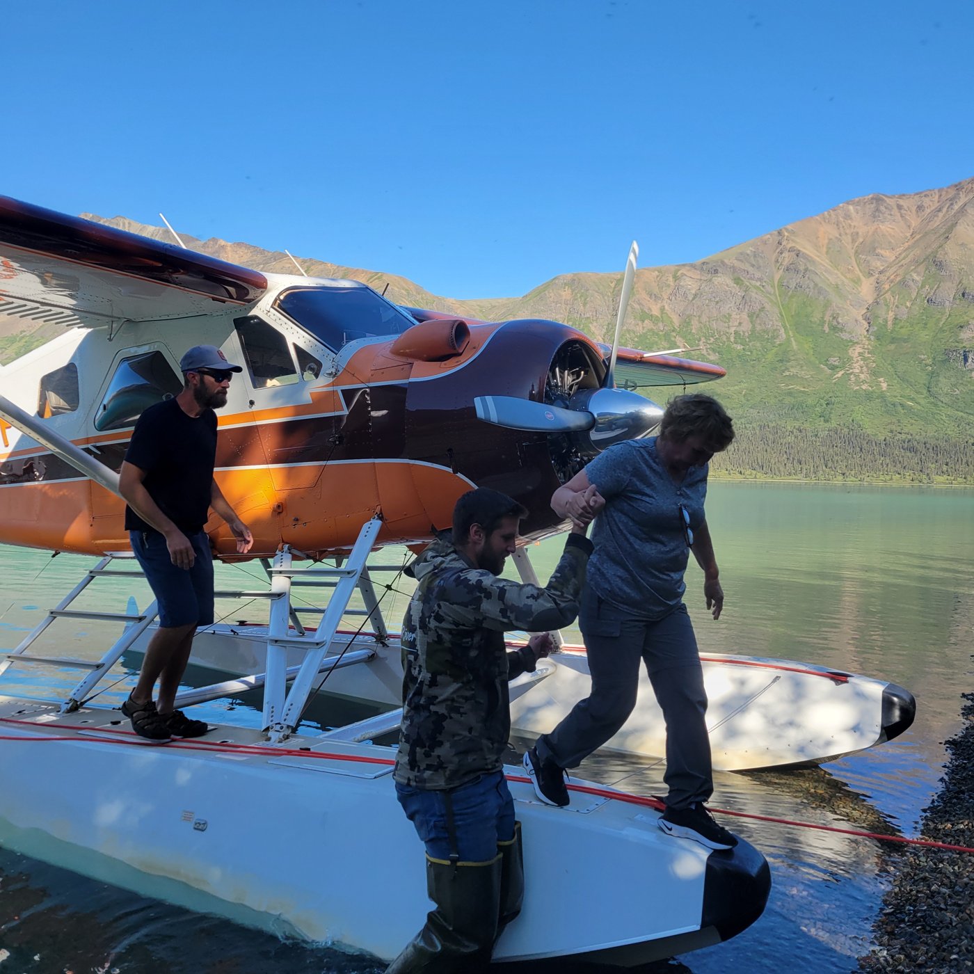 A guest being helped off a floatplane during a fly-out adventure