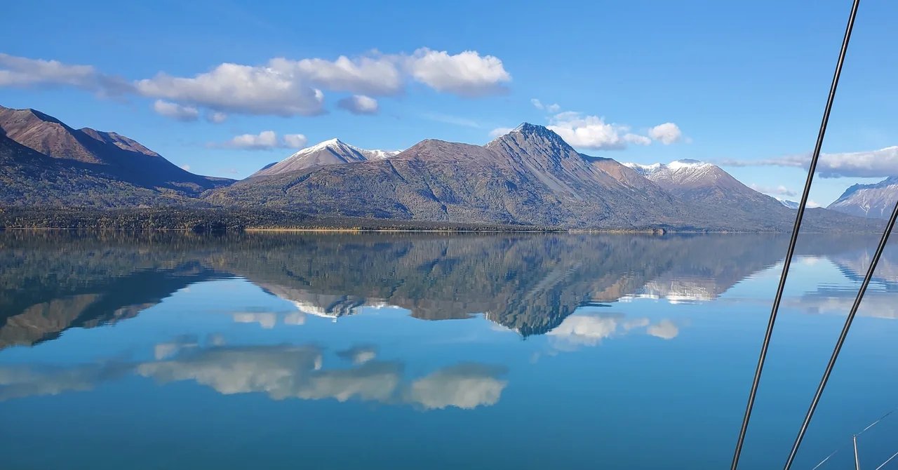 Mountains reflected in the still water of Lake Clark